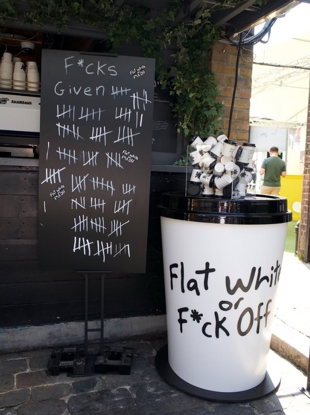 Flat White of F*ck Off Ask The Impossible giant factice giant coffee cup giant cup by Three Point featuring at 2026 MadFest London