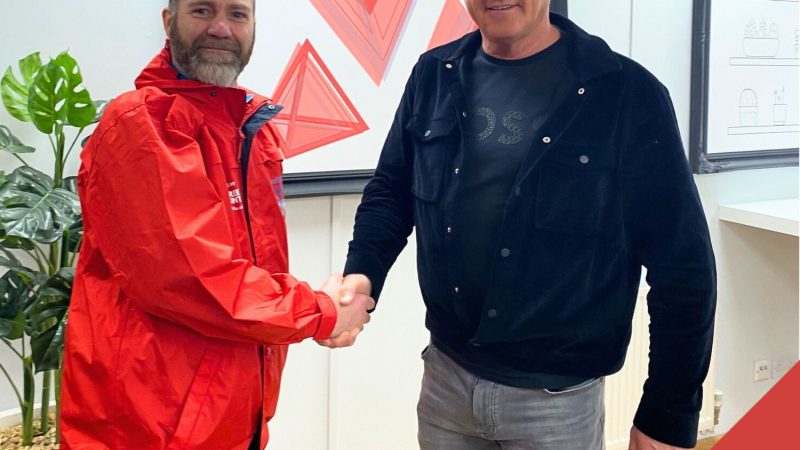 Steve Walsh shaking hands with Richard congratulating him on his Ride It campaign raising money for Crohn's and Colitis UK charity